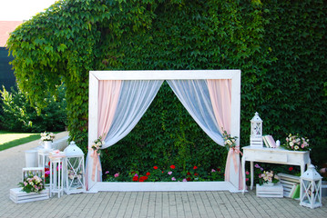 Arch for the Wedding Ceremony, decorated with Flowers and Decorative Accesories. Summer Wedding Party.
