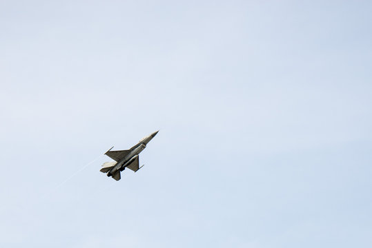 F16 Falcon Fighter Jet Flying On Blue Sky Background