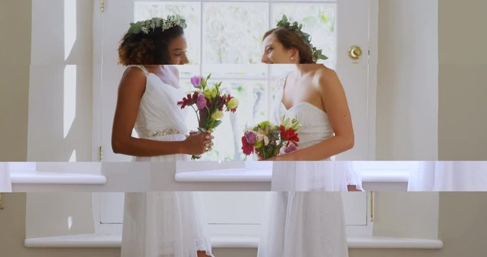 Two bridesmaid standing near the window with a bouquet  