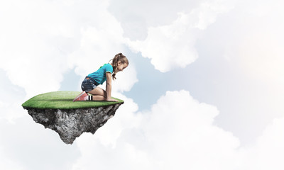 Concept of careless happy childhood with girl dreaming about something