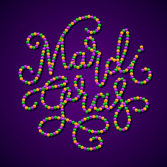 Mardi Gras lettering consist of gold, green, purple beads
