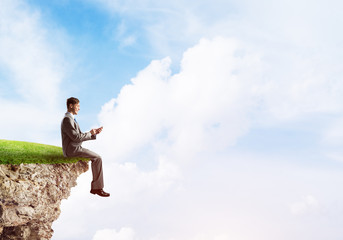 Businessman in suit with smartphone in hands send message