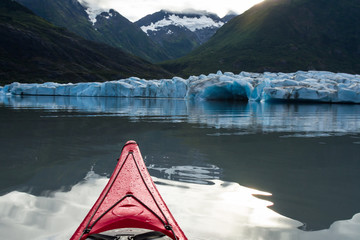 Kayak moving toward the calving face of the Spencer Glacier in Alaska