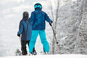 Fototapeta na wymiar Skiers in winter forest mountains, background