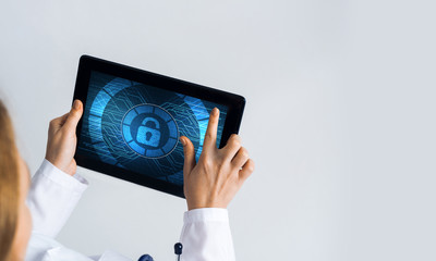 Close of female doctor hands working with tablet pc computer