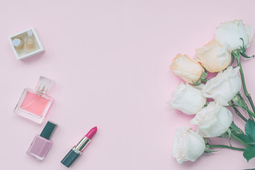 Beauty concept. Cosmetics.perfume and roses on a pastel pink background. Flat lay.