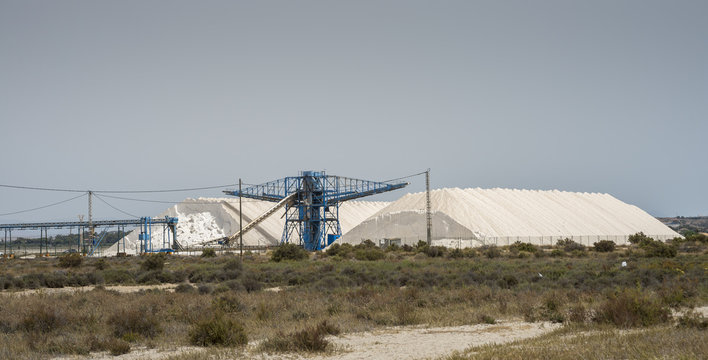 Mountains of marine salt form seawater evaporation. Photo taken in Santa Pola, Alicante, Spain, by the Mediterranean Sea