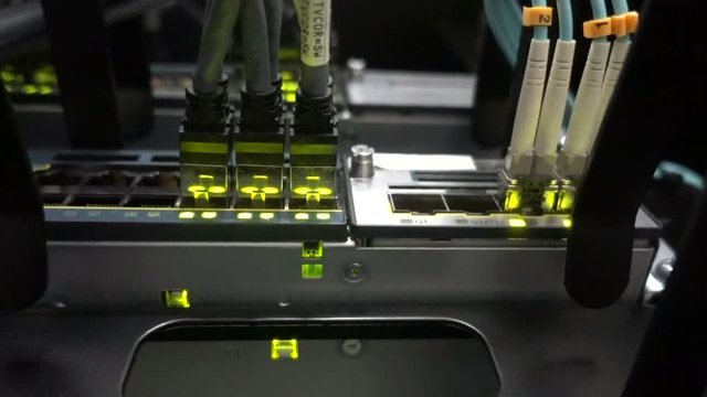 Fiber Optical connector interface. Rack Mounted Servers In A Server Room, Server rack audio cable. Severs computer in a rack at the large data center. bottom view