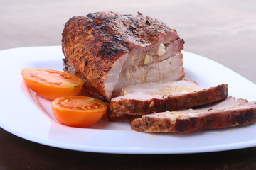 grilled pork chops with tomato and ketchup on plate.