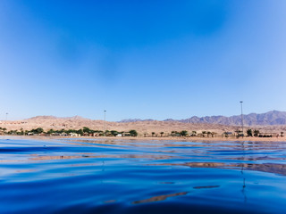 Water surface and view of the beach from sea water
