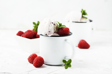 Sweet summer ice cream with raspberry on the white stone background
