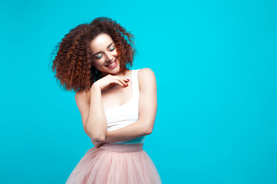 Beautiful smiling young woman on blue background