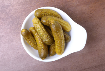 Pickles. Bowl of pickled gherkins cucumber with copy space. Cornichons.