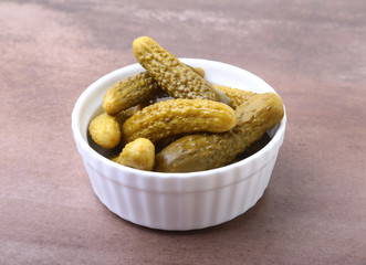 Pickles. Bowl of pickled gherkins cucumber with copy space. Cornichons.