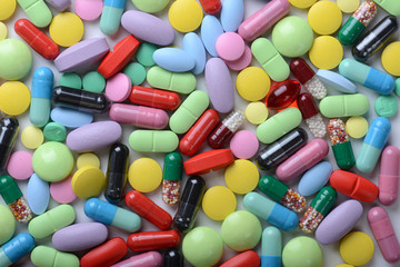 Fototapeta na wymiar Pharmacy theme. Multicolored Isolated Pills and Capsules