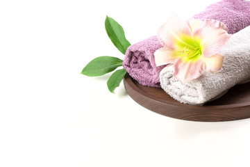 Obraz na płótnie Canvas Spa setting of towel, flower isolated on white with copy space.