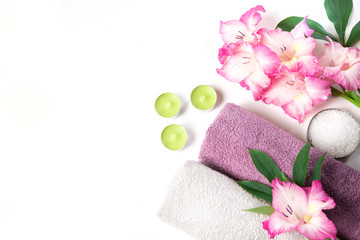 Spa setting of towel, flower isolated on white background with copy space.