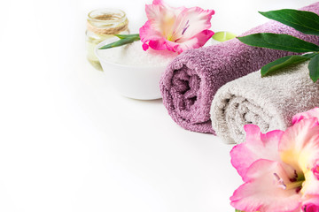 Spa setting of towel, flower isolated on white background with copy space.