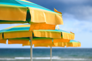 Beach umbrellas on a deserted beach, close-up