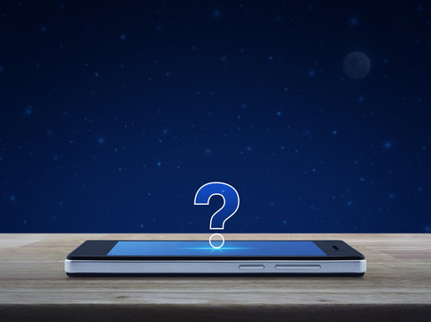 Question mark icon on modern smart phone screen on wooden table over fantasy night sky and moon, Customer support concept