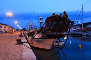 Harbour in the sunset with fishing boats, yachts. Pesaro, Marche, Italy