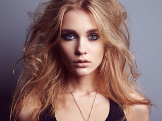 Portrait of young beautiful girl with blonde hair. Fashion photo Hairstyle. Make up. Vogue Style