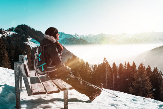 Woman backpacker relaxing on a bench