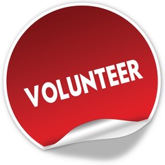 VOLUNTEER text on realistic red sticker on white background.