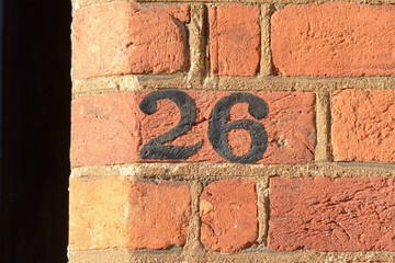 House number 26 sign painted on wall