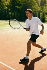 Sports. Male Player Playing Tennis Outdoors.