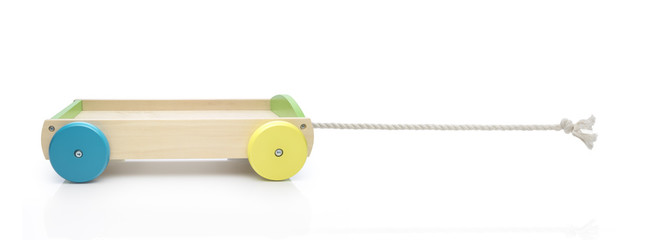 wood toy truck and braided cord against white background. Funny concept. Pull the truck