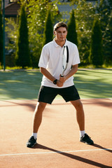 Sports. Male Player Playing Tennis Outdoors.