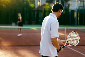 Young People Playing Tennis Outdoors