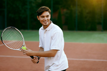 Man Playing Tennis Outdoors.