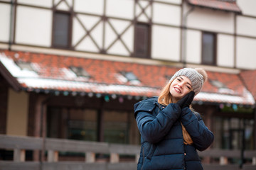 Attractive red haired woman wearing trendy outfit posing at the street in Kiev