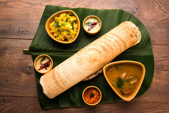 Masala dosa with chutney and sambar and potato sabzi. Cone, triangle or roll shape, selective focus
