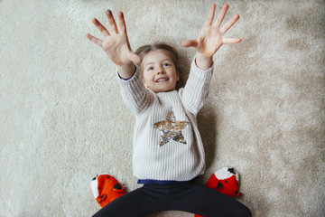 little kid trying to tickle mum on the carpet