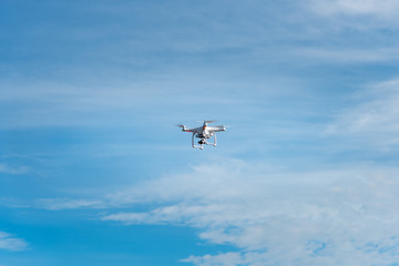 Fototapeta na wymiar Modern RC Drone / Quadcopter with camera flying