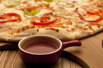 Vegetarian pizza on wooden board served with ketchup