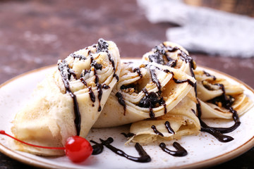 Tasty sweet pancakes with chocolate sauce