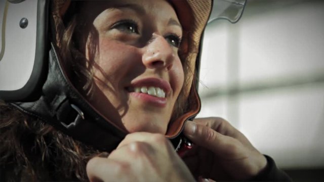 girl and boy wearing a helmet driving a moped