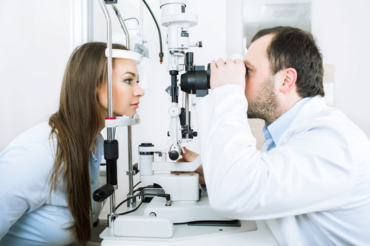 male doctor and a female patient, during a vision test, while in a medical clinic