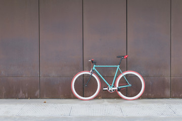 A City bicycle fixed gear on a brown wall