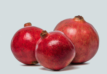 Big Ripe Red Granets or Garnets. Fruits of Red Ripe Pomegranate on the White Background. Vegetarian Concept