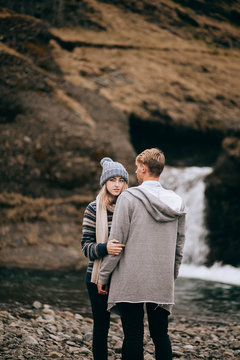 Iceland couple wearing Icelandic sweaters in beautiful nature landscape on Iceland. Woman and man model in typical Icelandic sweater.