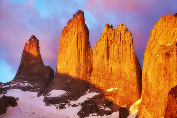 Torres del Paine famous rock formations at pink sunrise, Patagonia, Chile.