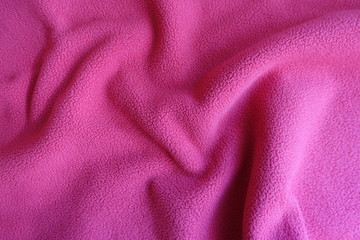 Folded bright ruby red polar fleece fabric © Anna