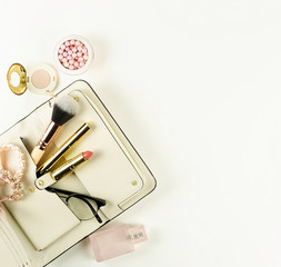 Female fashionable stylish accessories and make up cosmetics. bag, glasses, lipstick, mascara, powder, brush on a white background. Beauty blog concept. Flat lay. Copy space.top view