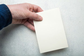 A5 vertical cream layout paper sheet in hand.