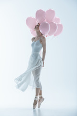 tender ballet dancer in white dress with pink balloons, isolated on white